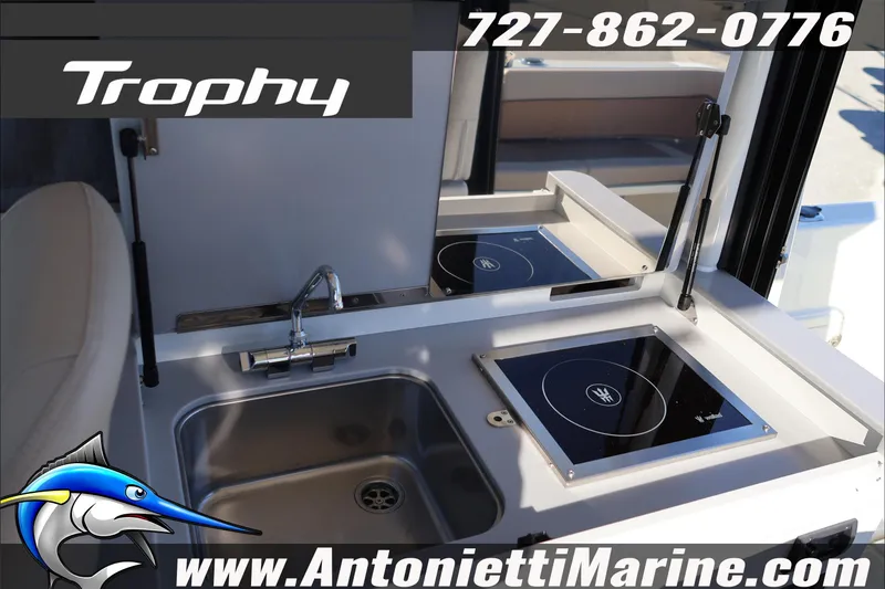 Slide: The Image of 2026 Bayliner Trophy T29 Explorer boat kitchen with sink and stove. - 27
