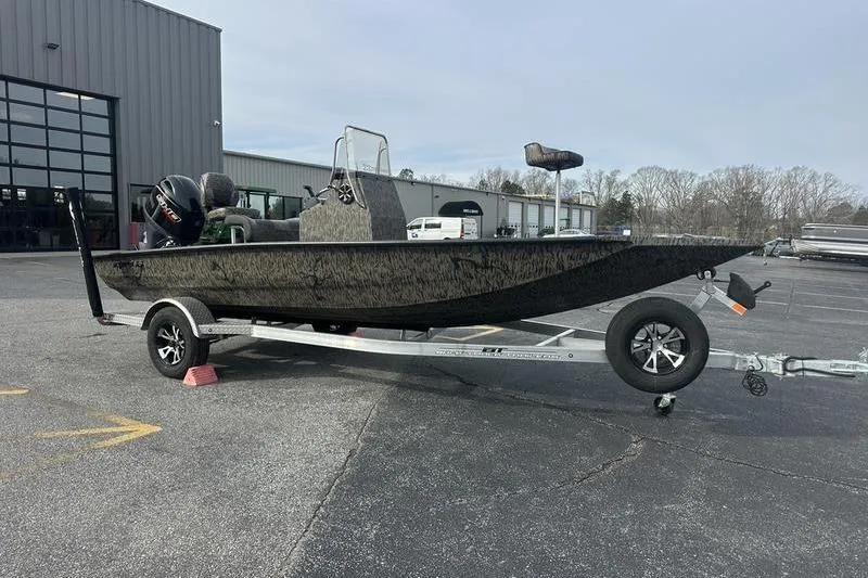 The Image of 2026 Xpress H190B Bay boat on trailer in parking lot. - 1