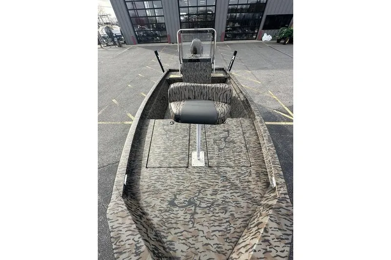 Slide: The Image of 2026 Xpress H190B Bay boat with camouflage design, parked outdoors. - 10