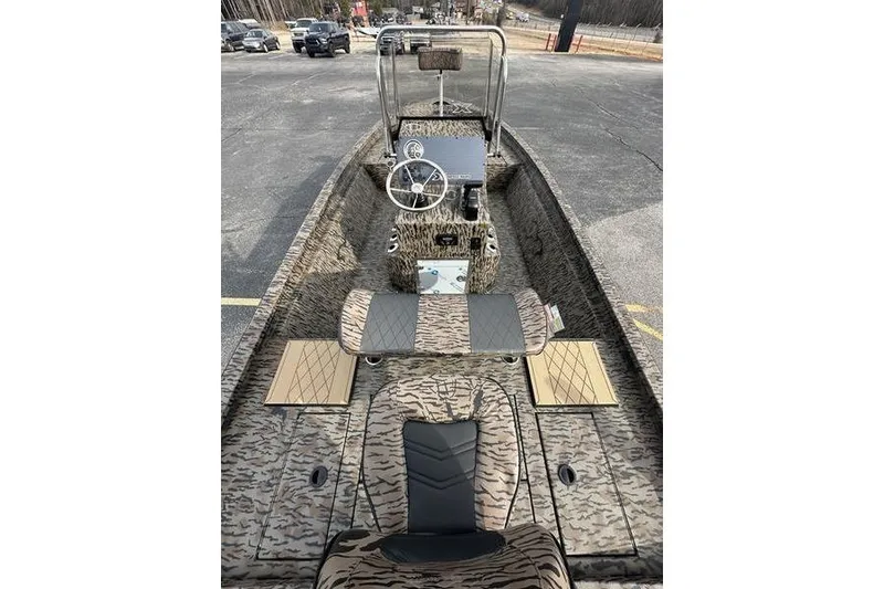 Slide: The Image of 2026 Xpress H190B Bay boat interior with camouflage design and steering console. - 8