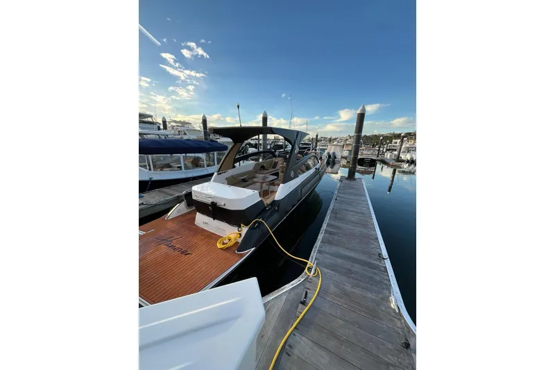 Slide: The Image of Luxury Hanover 305 yacht docked at marina, 2026 model, under clear blue sky. - 4