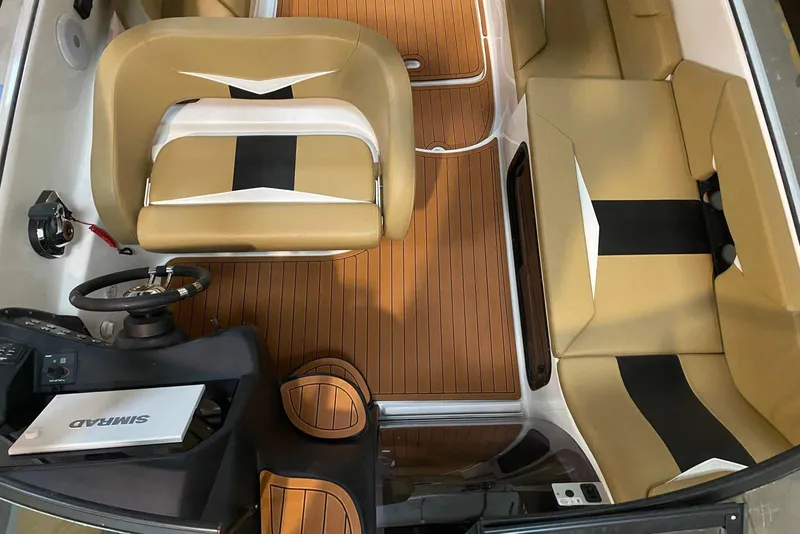 Slide: The Image of Interior of 2026 Hanover 305 boat with tan seating and wood-style flooring. - 7