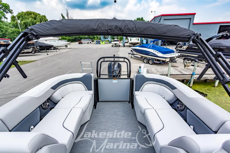 Slide: The Image of 2026 Godfrey Sweetwater 2286 SBC pontoon boat with spacious seating at marina. - 16