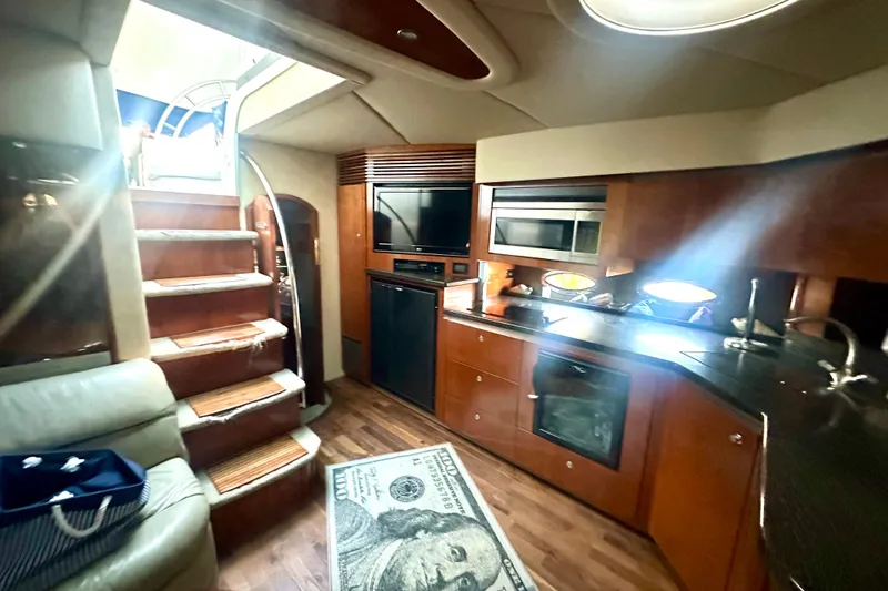 Slide: The Image of Luxurious interior of 2005 Cruisers Yachts 500 Express with modern kitchen and staircase. - 23