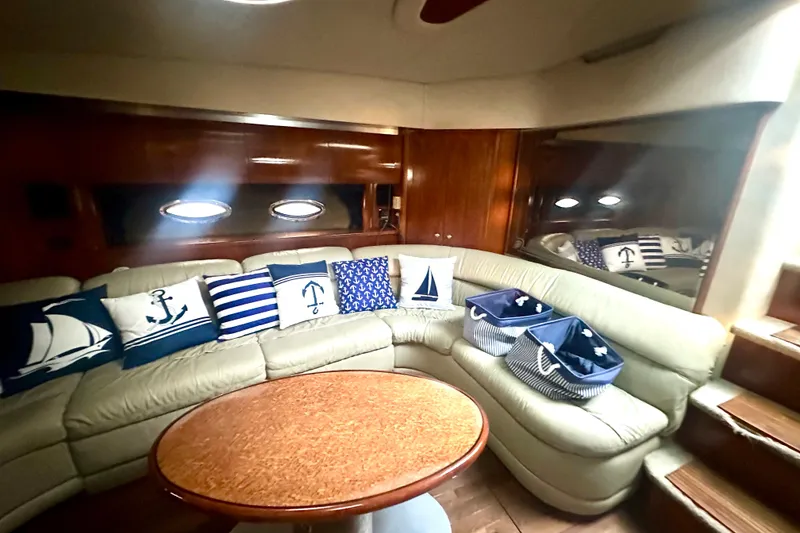 Slide: The Image of Luxurious 2005 Cruisers Yachts 500 Express interior with nautical-themed decor and cozy seating. - 26
