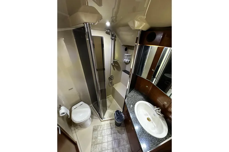 Slide: The Image of Luxurious bathroom in 2005 Cruisers Yachts 500 Express, featuring modern fixtures and elegant design. - 33