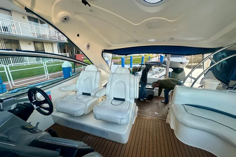 Slide: The Image of 2005 Cruisers Yachts 500 Express interior with white seating and wooden flooring. - 19