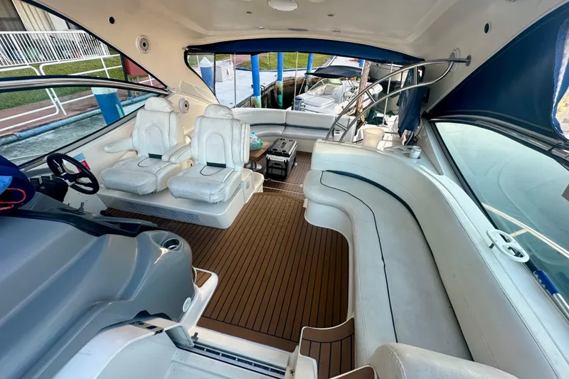 Slide: The Image of 2005 Cruisers Yachts 500 Express interior with white seating and wooden flooring. - 21