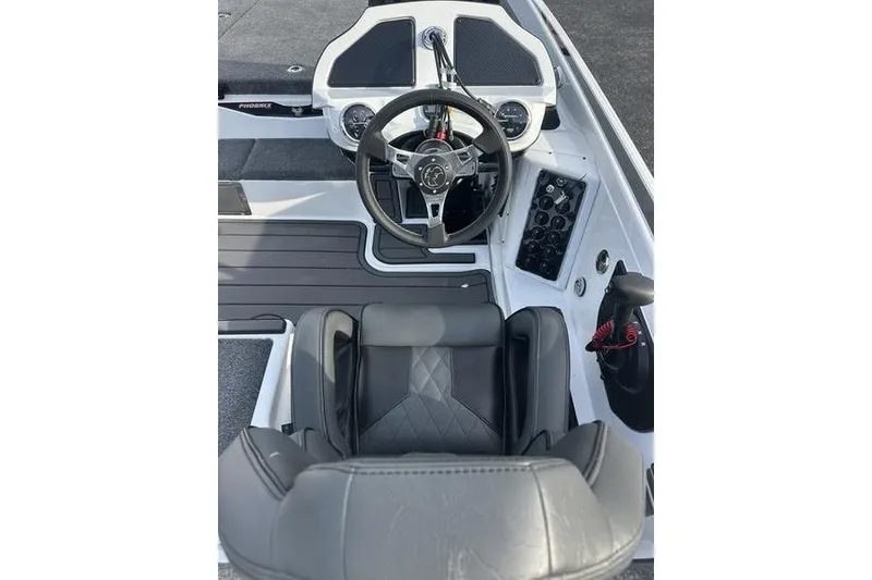 Slide: The Image of 2026 Phoenix 921 Elite X boat cockpit with steering wheel and control panel. - 4