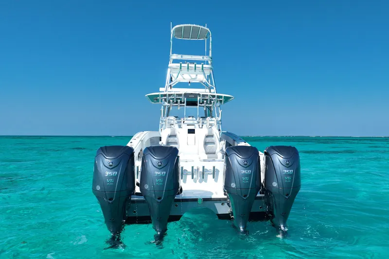 Slide: The Image of 2024 Freeman 42 boat with four powerful outboard engines on clear turquoise water. - 10