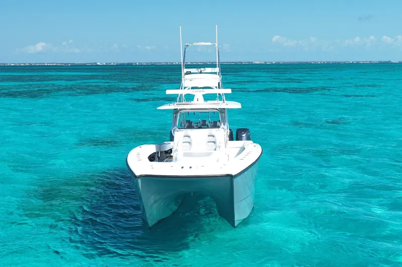 Slide: The Image of 2024 Freeman 42 boat on clear turquoise water, showcasing sleek design and modern features. - 12