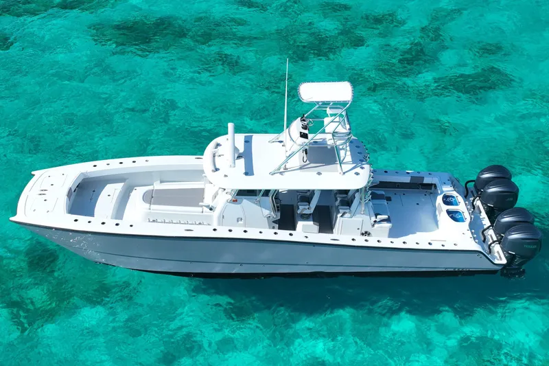 Slide: The Image of 2024 Freeman 42 boat on clear turquoise water, aerial view. - 14