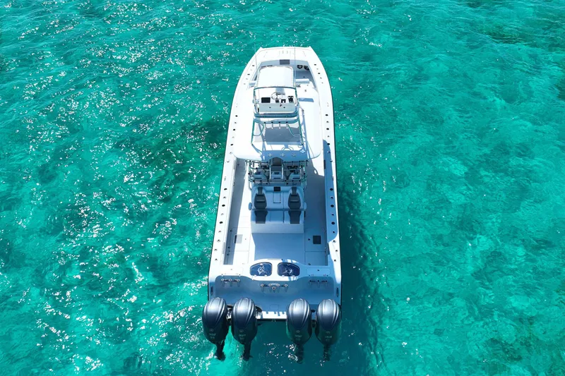 Slide: The Image of 2024 Freeman 42 boat on clear turquoise water, aerial view. - 16