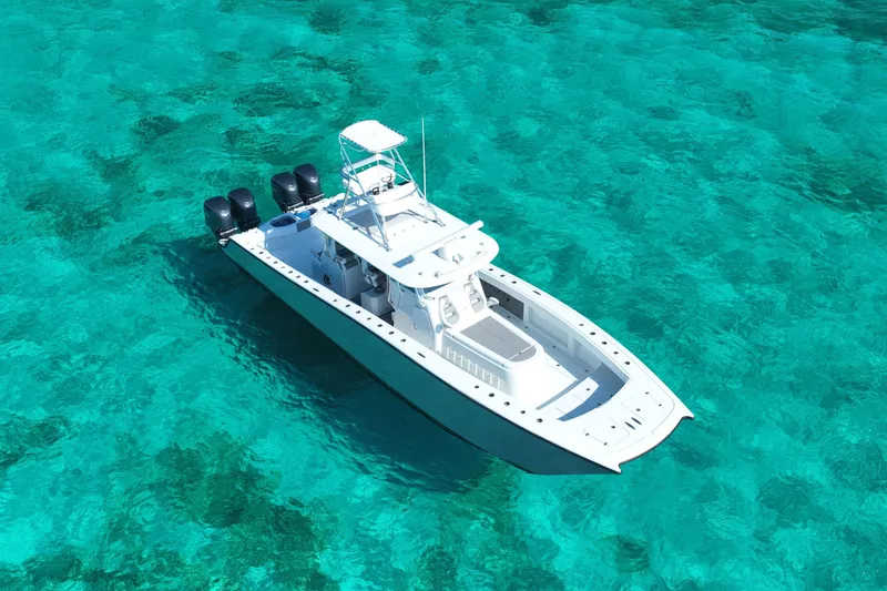Slide: The Image of 2024 Freeman 42 boat on clear turquoise water, aerial view. - 19