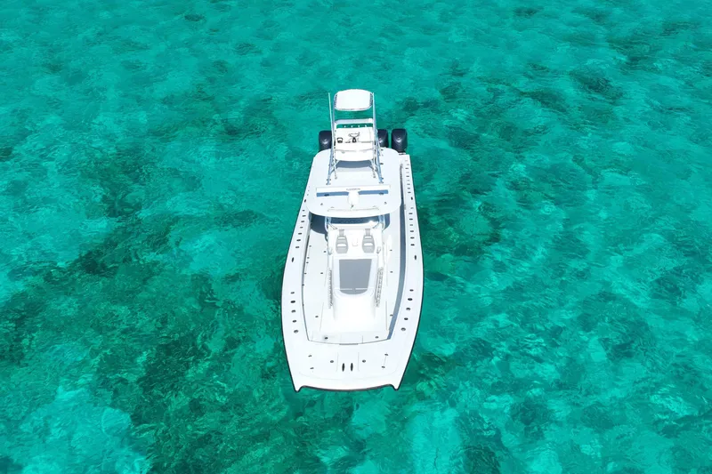 Slide: The Image of 2024 Freeman 42 boat on clear turquoise water, aerial view. - 20
