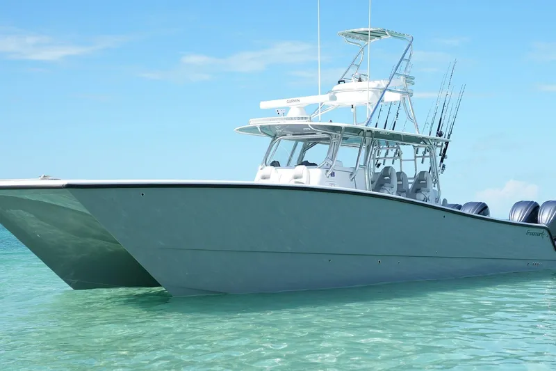 Slide: The Image of 2024 Freeman 42 boat on clear turquoise water, front view. - 3
