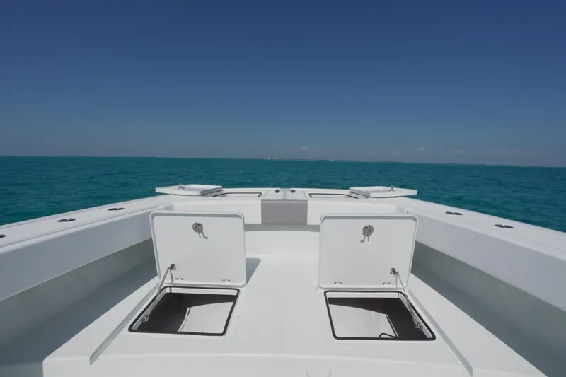 Slide: The Image of 2024 Freeman 42 boat deck with open storage compartments, set against a clear blue ocean. - 31