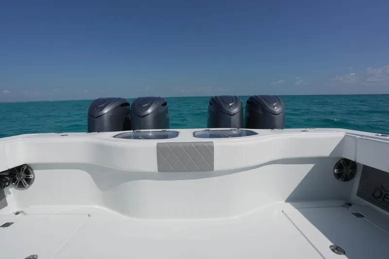 Slide: The Image of 2024 Freeman 42 boat with four engines on open sea under clear sky. - 36