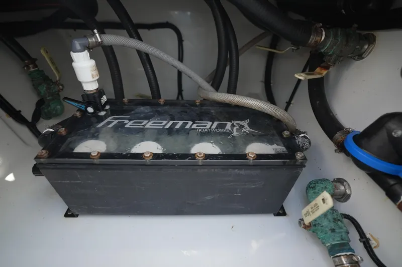 Slide: The Image of Engine compartment of 2024 Freeman 42 boat with visible hoses and components. - 48