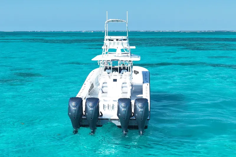 Slide: The Image of 2024 Freeman 42 boat with four engines on clear turquoise water. - 9