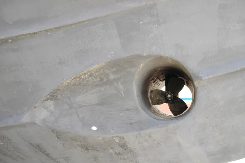 Slide: The Image of Close-up of a 1997 Symbol 50 Pilothouse boat propeller in a tunnel. - 100