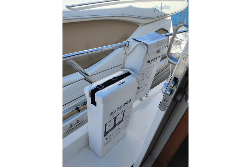 Slide: The Image of Life raft storage on a 1997 Symbol 50 Pilothouse yacht deck. - 12