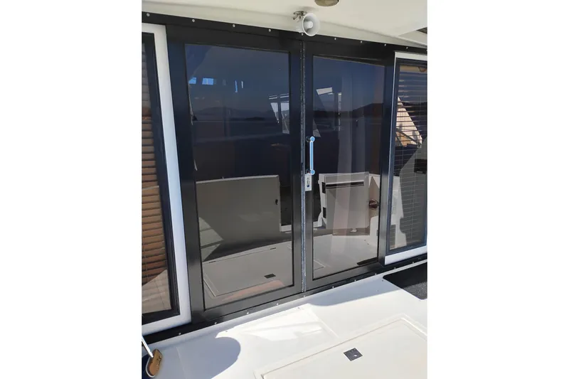 Slide: The Image of Glass doors on a 1997 Symbol 50 Pilothouse yacht, reflecting sunlight. - 13