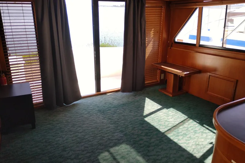 Slide: The Image of Interior of a 1997 Symbol 50 Pilothouse yacht with carpet and wooden accents. - 16