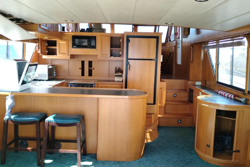 Slide: The Image of Interior of a 1997 Symbol 50 Pilothouse yacht with wooden cabinetry and modern amenities. - 19