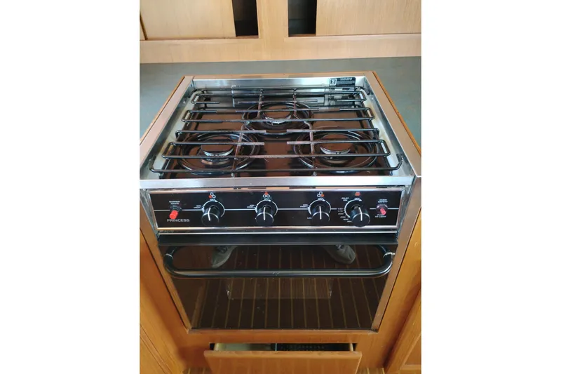 Slide: The Image of Stove and oven unit in a 1997 Symbol 50 Pilothouse yacht kitchen. - 23