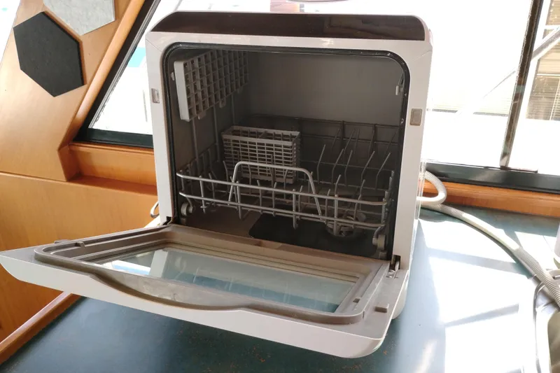 Slide: The Image of Compact dishwasher inside a 1997 Symbol 50 Pilothouse yacht, open and ready for use. - 27