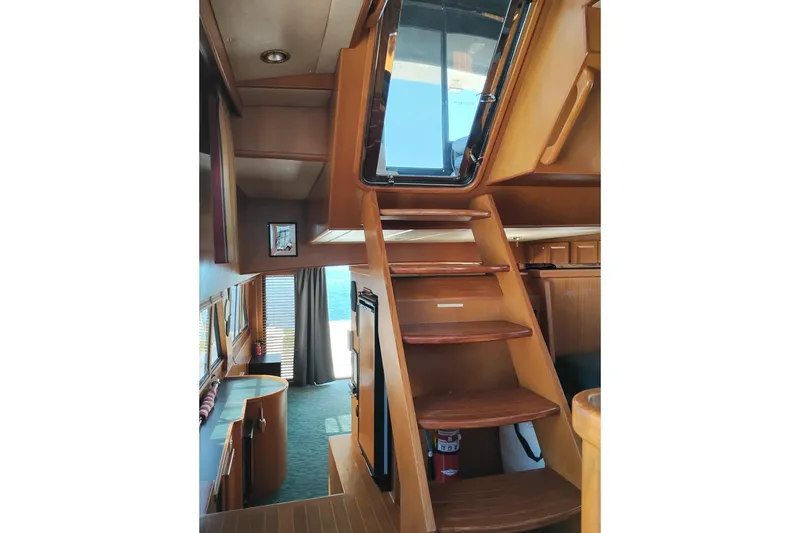 Slide: The Image of Interior view of a 1997 Symbol 50 Pilothouse yacht with wooden stairs and nautical decor. - 29
