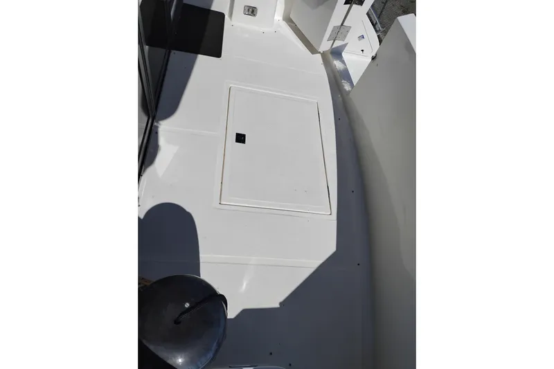 Slide: The Image of Deck area of a 1997 Symbol 50 Pilothouse boat, featuring a hatch and clean surface. - 3