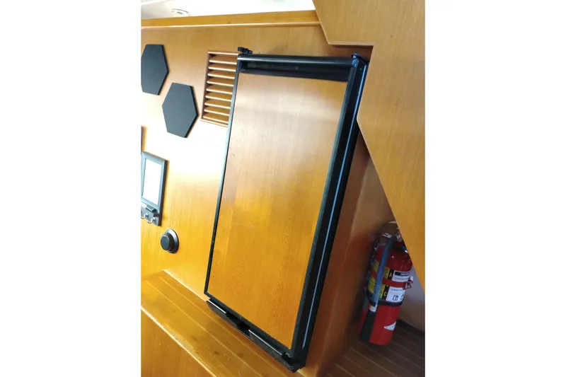 Slide: The Image of Wooden interior of a 1997 Symbol 50 Pilothouse with hexagonal decor and fire extinguisher. - 30