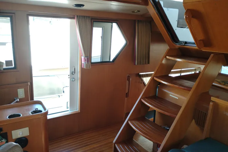 Slide: The Image of Interior of a 1997 Symbol 50 Pilothouse yacht with wooden stairs and windows. - 31