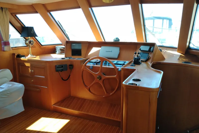 Slide: The Image of Interior of a 1997 Symbol 50 Pilothouse yacht with wooden helm and navigation equipment. - 32