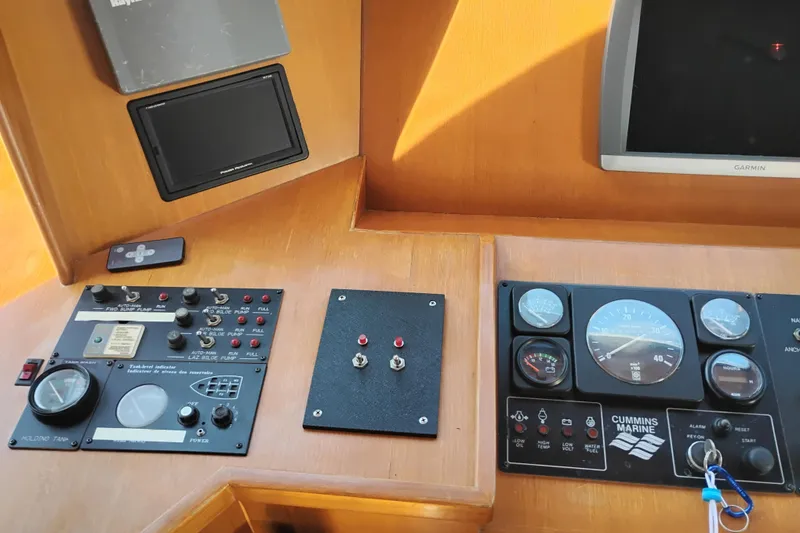 Slide: The Image of Control panel of a 1997 Symbol 50 Pilothouse boat with gauges and switches. - 35