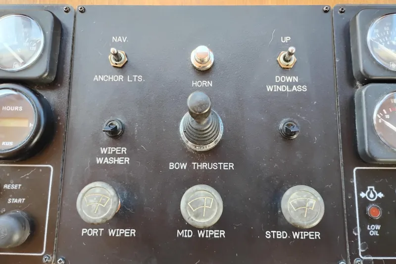 Slide: The Image of Control panel of a 1997 Symbol 50 Pilothouse boat with various switches and gauges. - 37