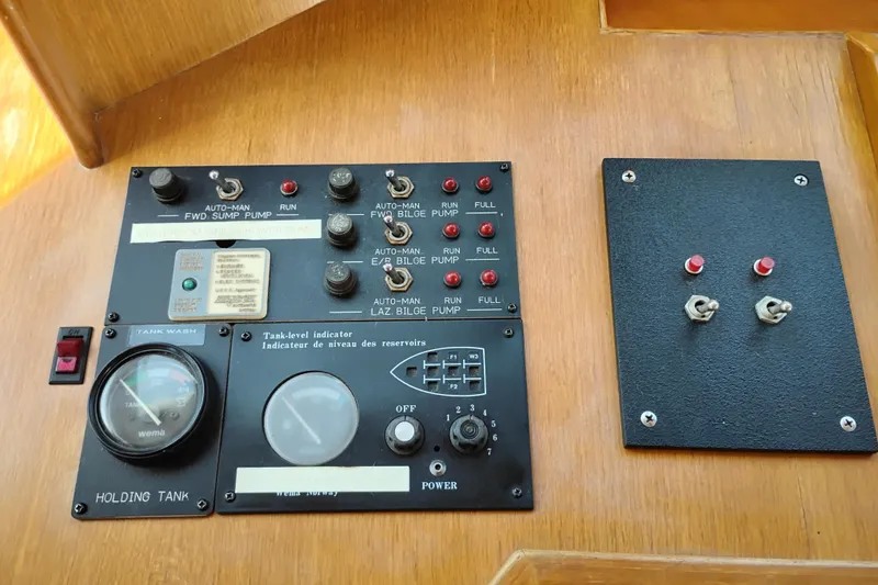 Slide: The Image of Control panel of a 1997 Symbol 50 Pilothouse yacht with gauges and switches. - 38