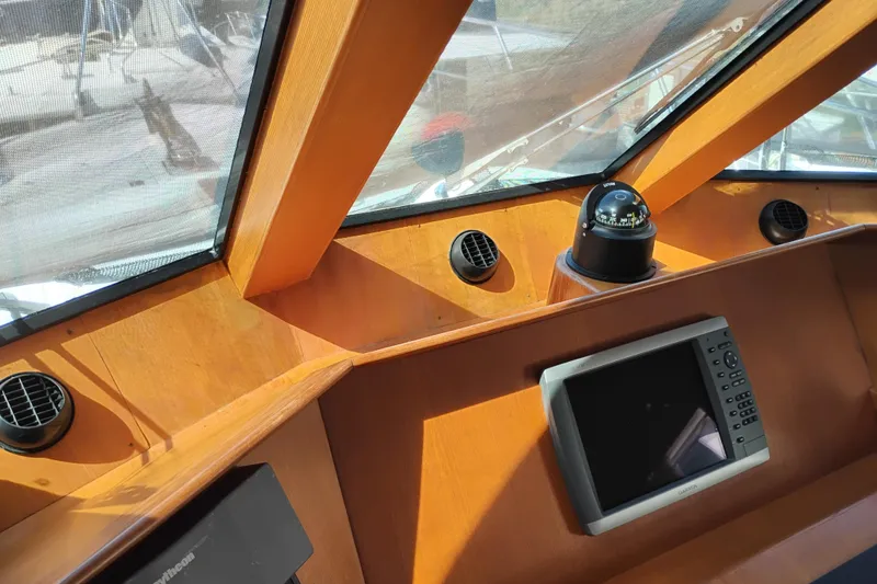 Slide: The Image of 1997 Symbol 50 Pilothouse helm with compass and navigation display. - 40