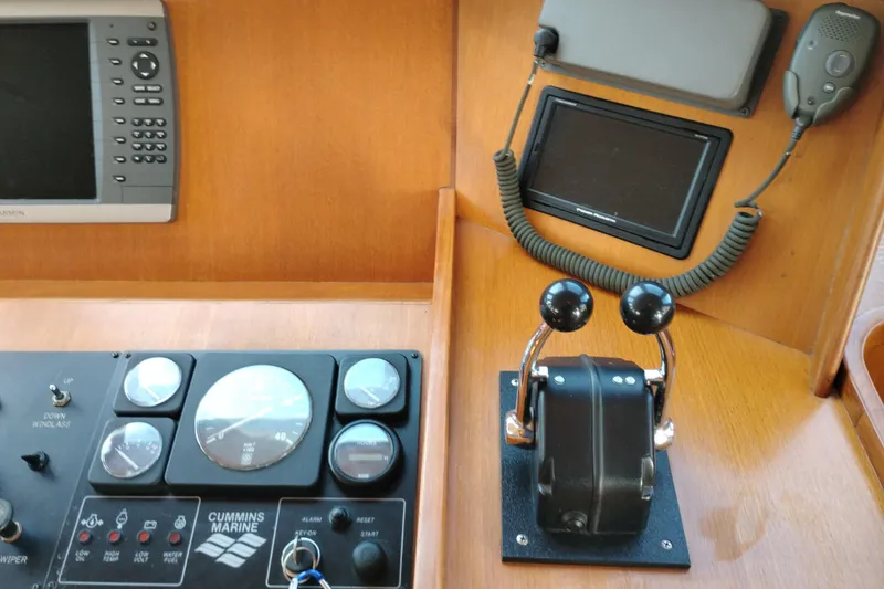 Slide: The Image of Control panel of a 1997 Symbol 50 Pilothouse with marine gauges and throttle levers. - 41