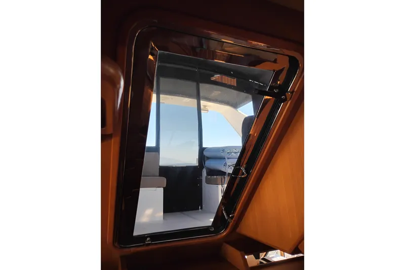 Slide: The Image of Interior view of a 1997 Symbol 50 Pilothouse yacht, showcasing a sleek window design. - 43
