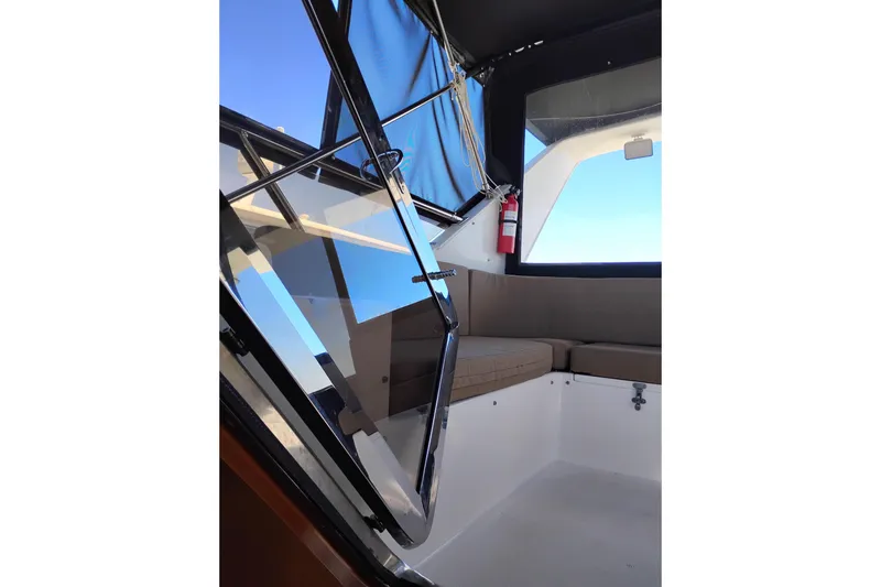 Slide: The Image of Interior view of a 1997 Symbol 50 Pilothouse yacht with seating and a fire extinguisher. - 44
