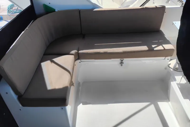 Slide: The Image of Cozy seating area on a 1997 Symbol 50 Pilothouse yacht, featuring beige cushions. - 46