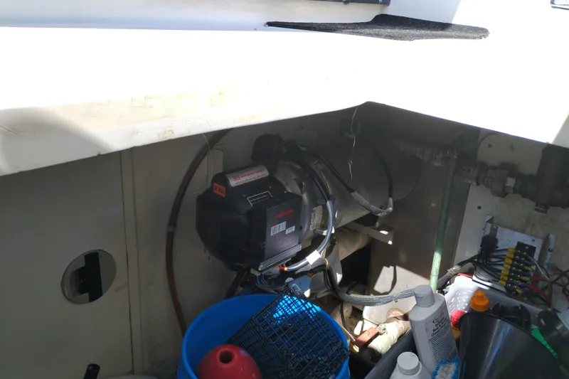 Slide: The Image of Engine compartment of a 1997 Symbol 50 Pilothouse boat with maintenance supplies. - 5