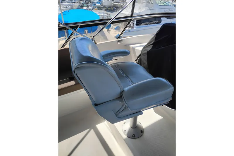 Slide: The Image of Captain's chair on 1997 Symbol 50 Pilothouse yacht, overlooking marina. - 51