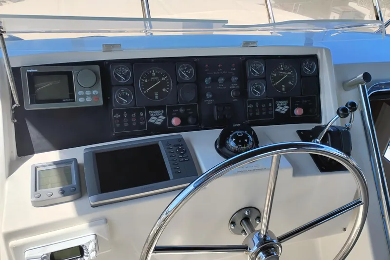 Slide: The Image of 1997 Symbol 50 Pilothouse helm with navigation instruments and steering wheel. - 53