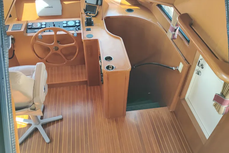 Slide: The Image of 1997 Symbol 50 Pilothouse interior with wooden helm and navigation equipment. - 57