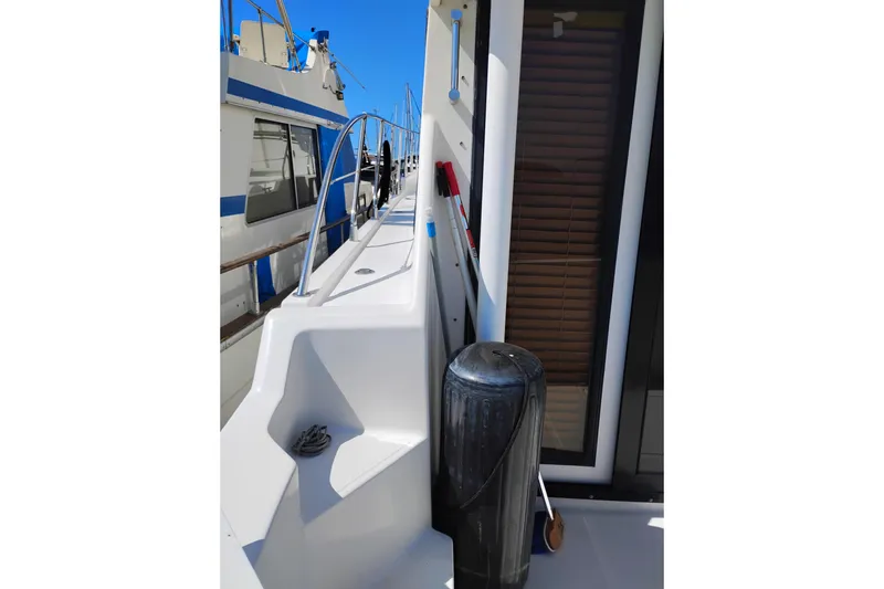Slide: The Image of 1997 Symbol 50 Pilothouse yacht deck with railing and dock fender. - 6