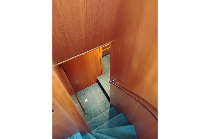 Slide: The Image of Interior staircase of 1997 Symbol 50 Pilothouse yacht with wooden walls and carpeted steps. - 60